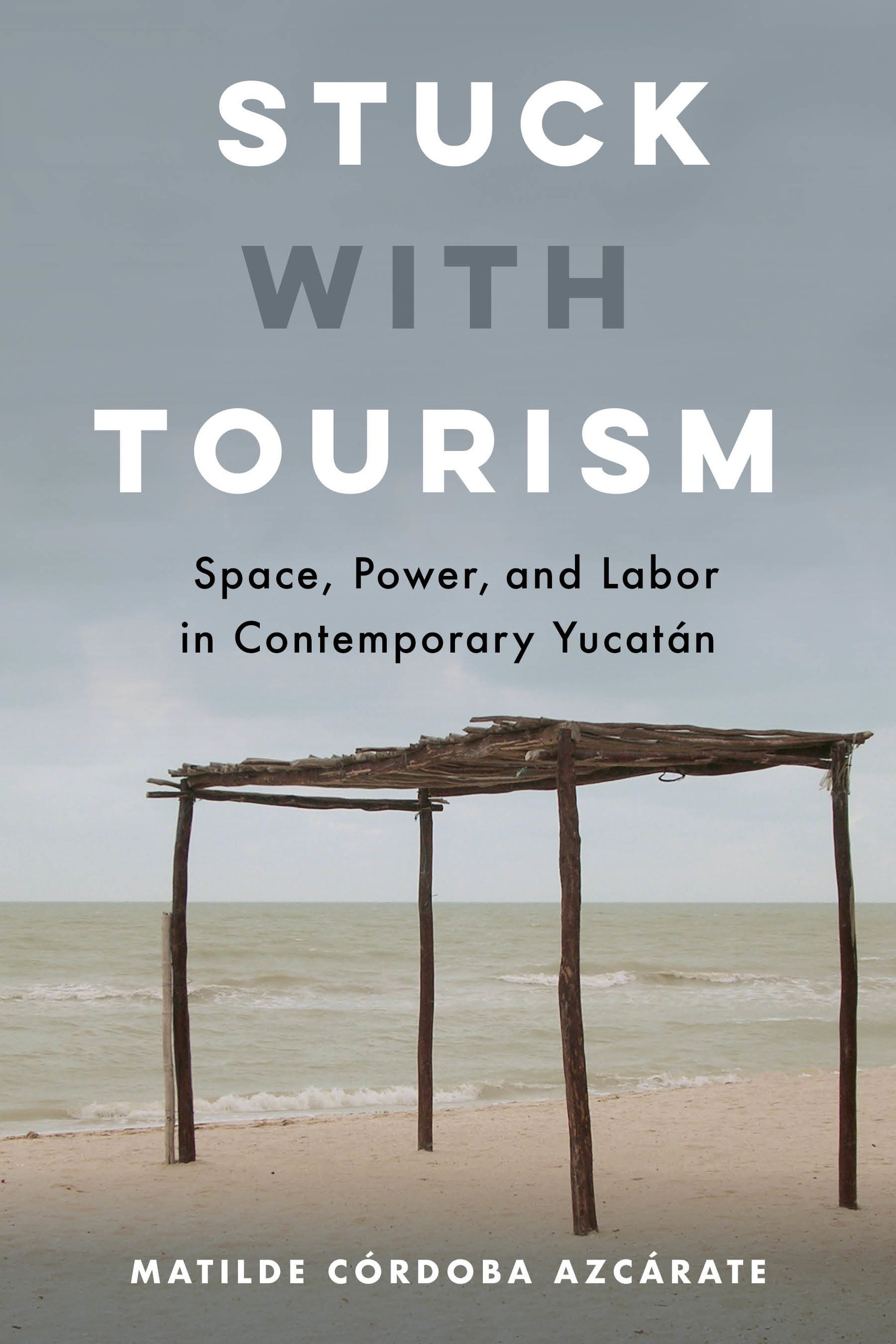book cover of Córdoba Azcárate's "Stuck with Tourism" showing a wooden structure in the desert