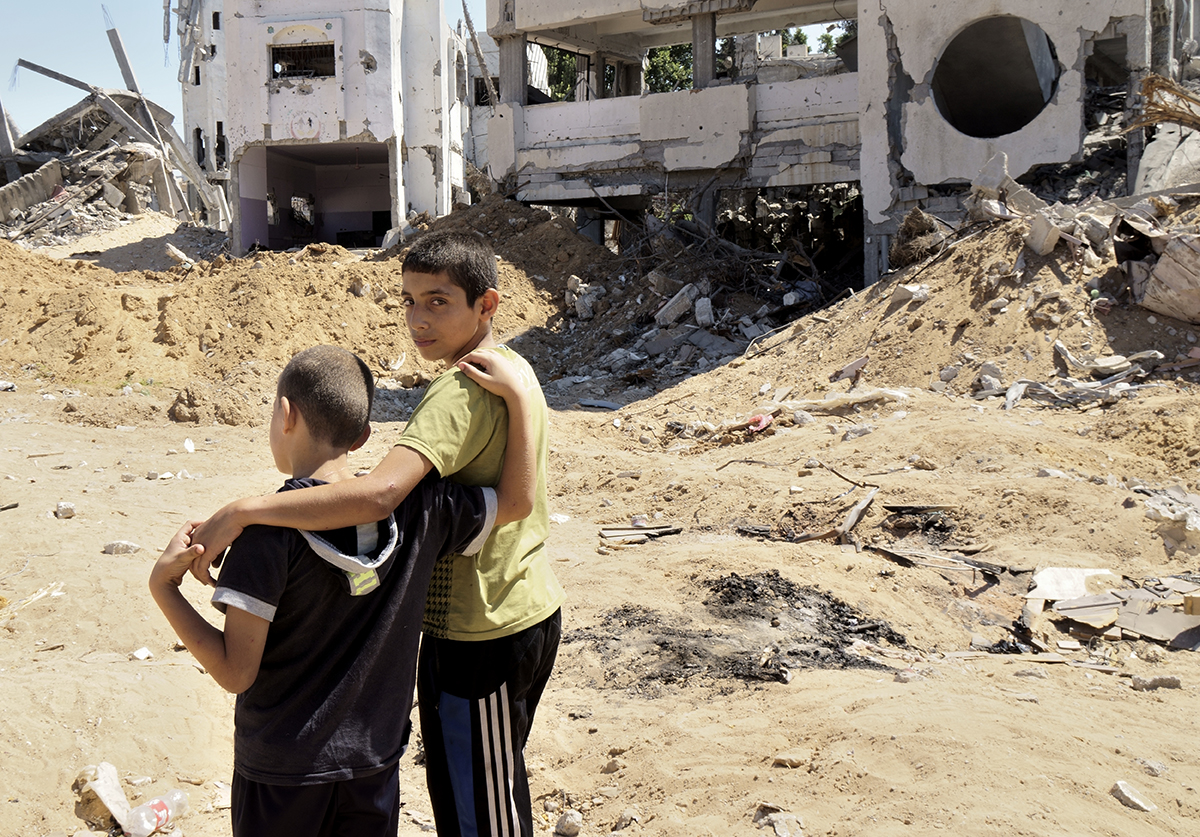 Two brothers in front of their house in the Shuja’iya neighborhood destroyed during Operation Protective Edge (2014).  Photo by Gary Fields