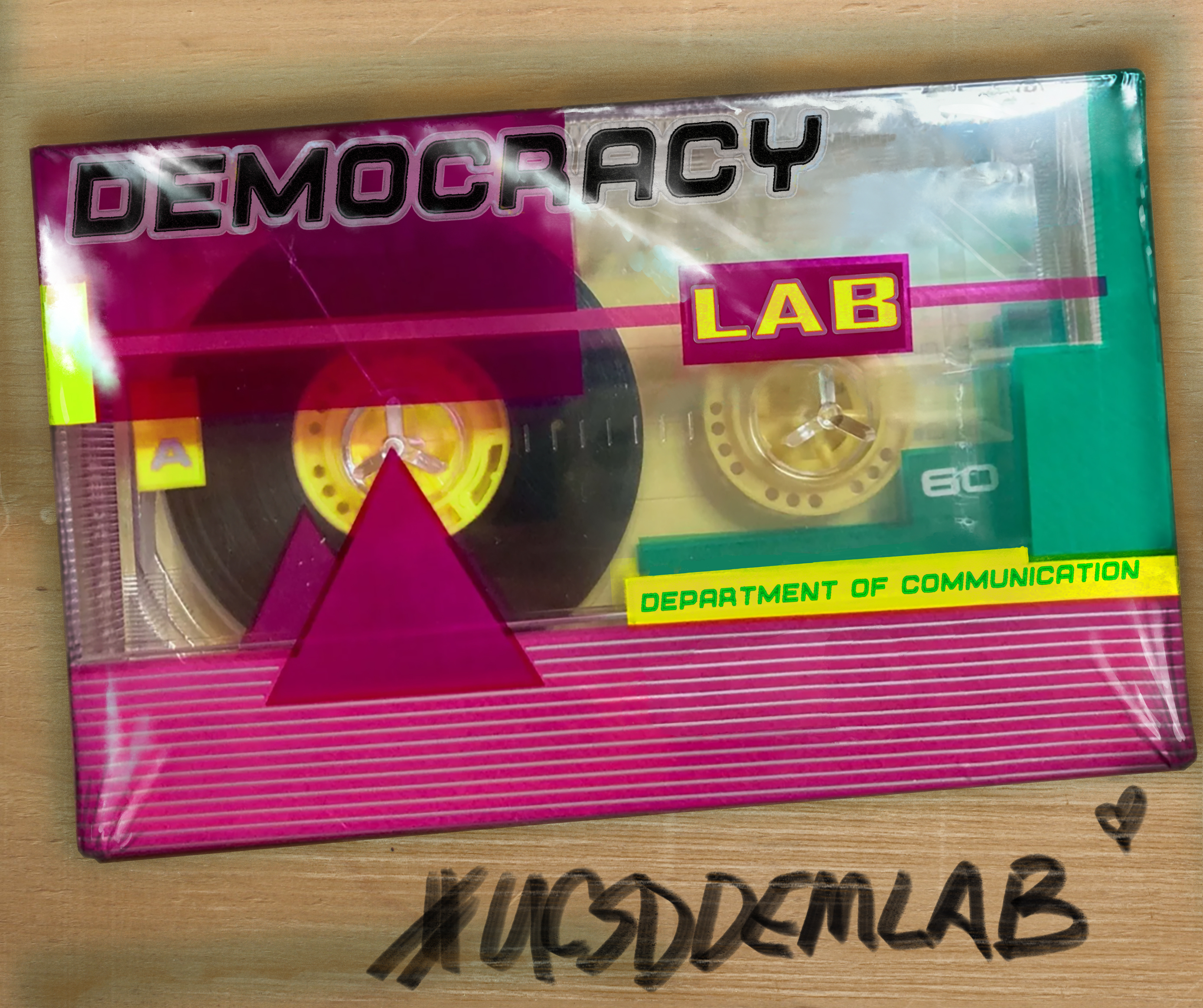Vintage 80s blank casette tape with UCSD Democracy Lab printed as the logo and handwritten #UCSDDEMLAB