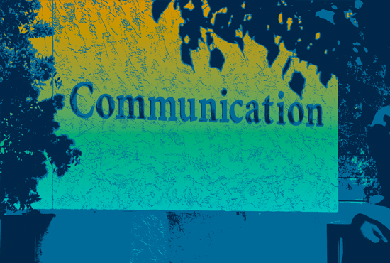 Photo of the COMMUNICATION sign on the building. Photo is artistically changed to blue and green tones.