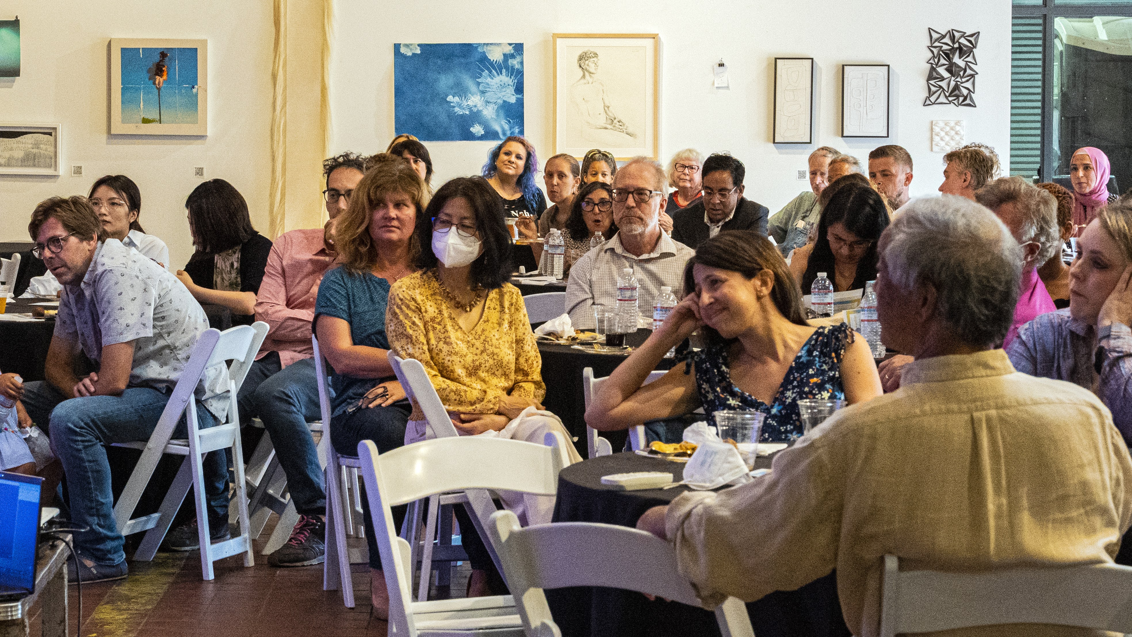 Audience listening to testimonials about Dan Hallin